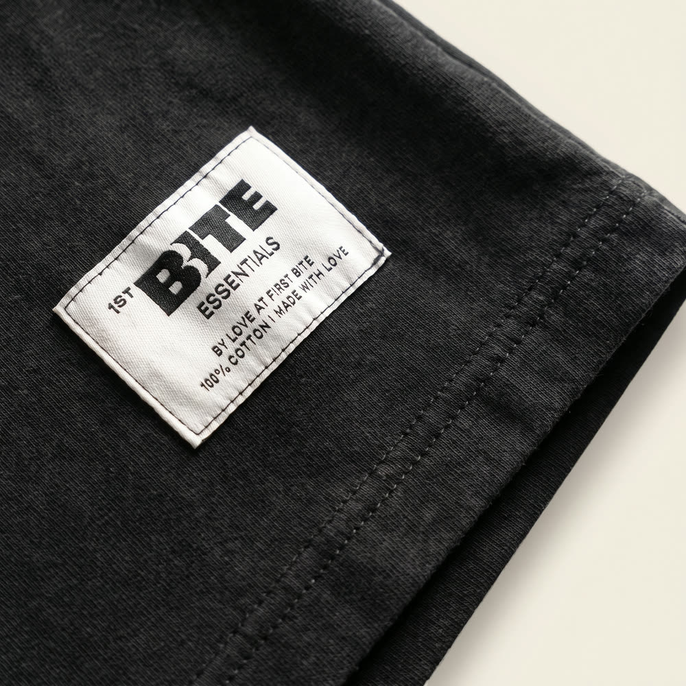 Sewn-in hem label reading 1ST BITE Essentials