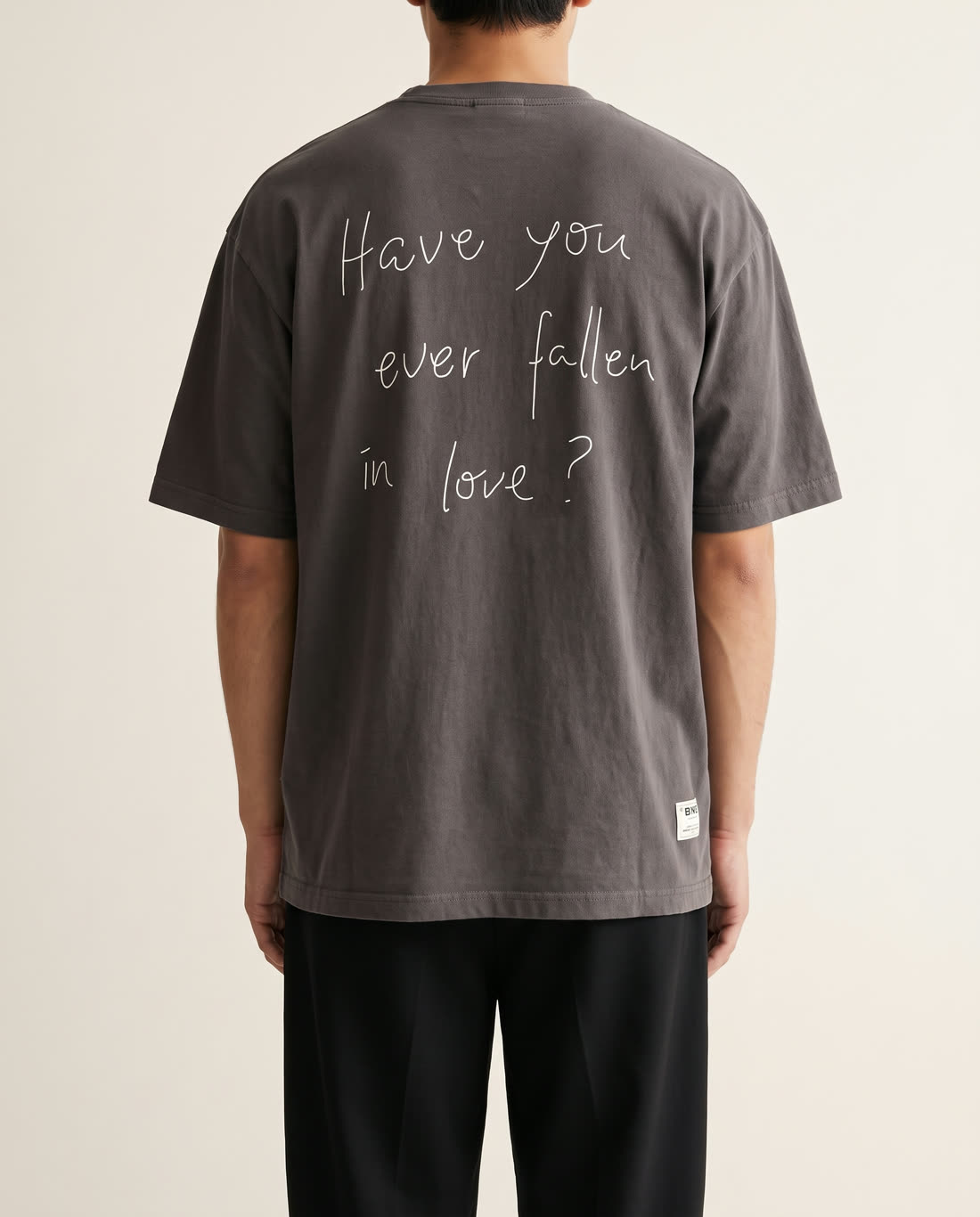 The Essentials Tee on a model, back view with print